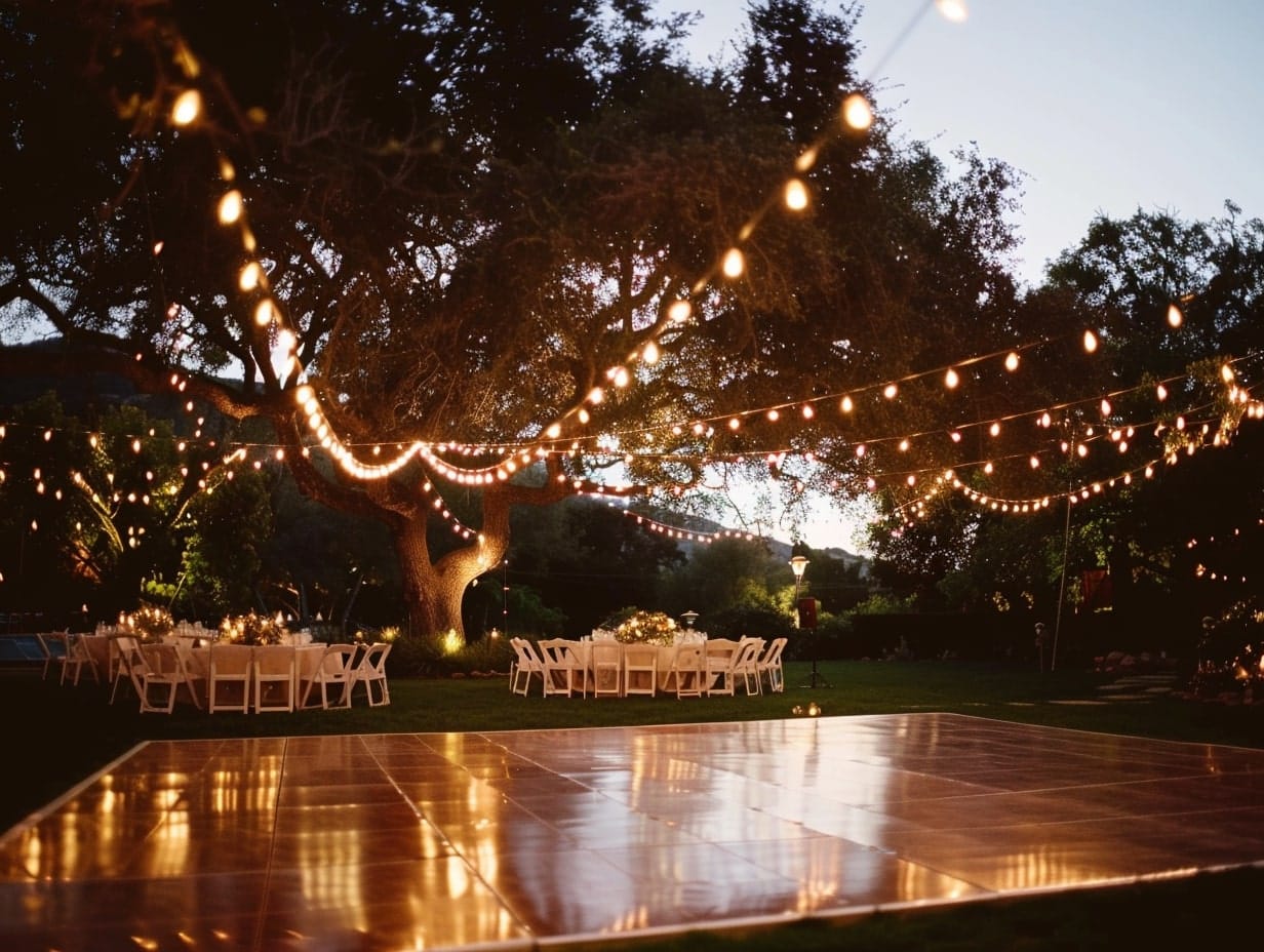 outdoor wedding dance floor surrounded by string lights